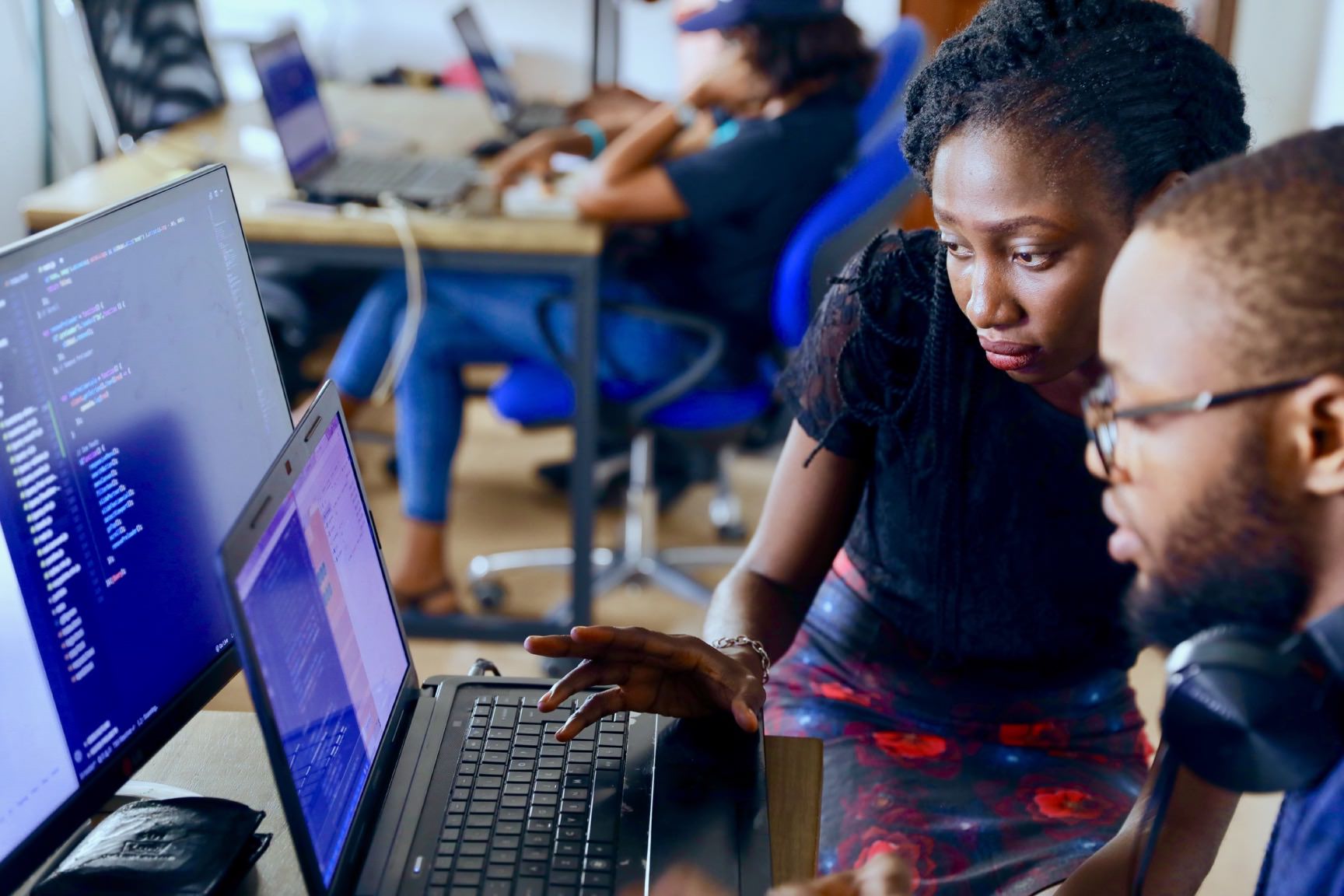 Woman and man and working on a laptop together in an office